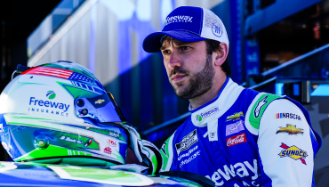 Daniel Suarez looking at his Freeway Insurance NASCAR helmet