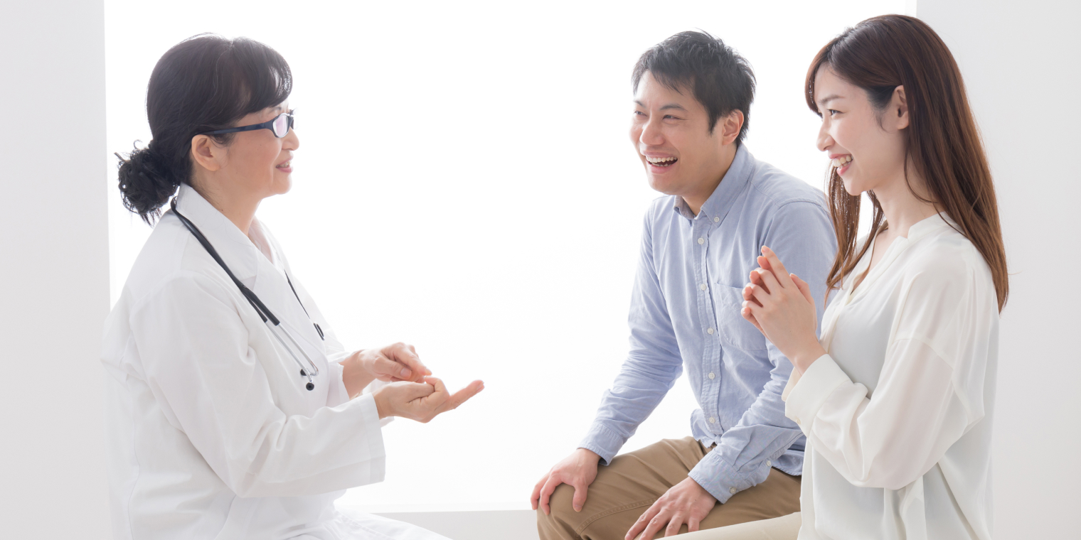 Doctor explaining Asian American family about health insurance
