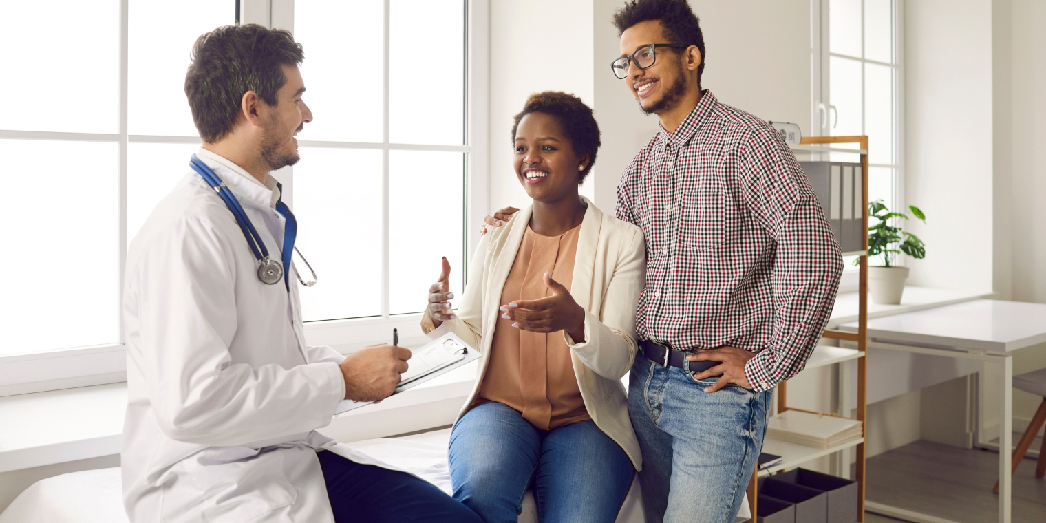 Doctor getting information about health from a female patient and her partner