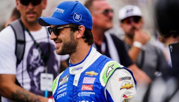 Daniel Suarez with Freeway Insurance Nascar uniform and a crowd behind him