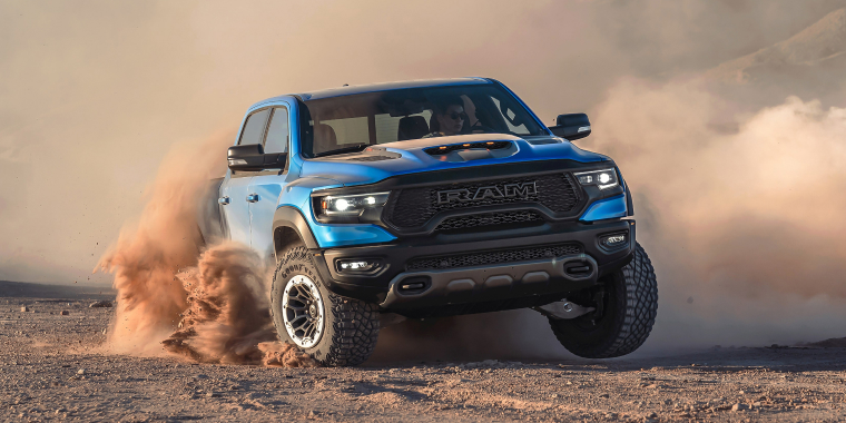 Front view of blue Dodge Ram in the dessert