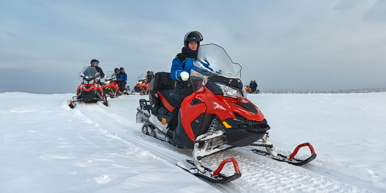 Group of snowmobile riders having fun