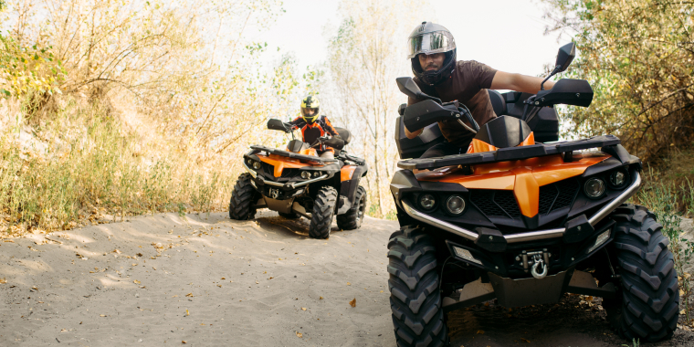 Two people enjoy off-roading on their ATVs