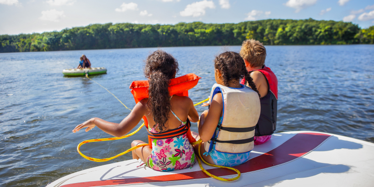 Family tubing from a boat on an inland lake