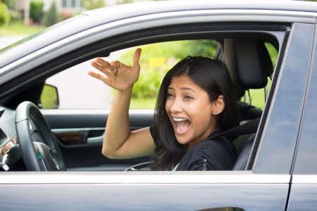 Happy young Hispanic woman shows off her car keys