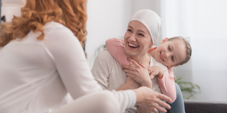 Happy family of mother with cancer and two children