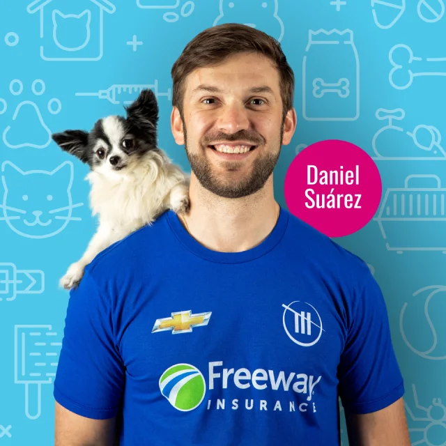 Daniel Suarez with a Freeway Insurance shirt and a dog on his shoulder