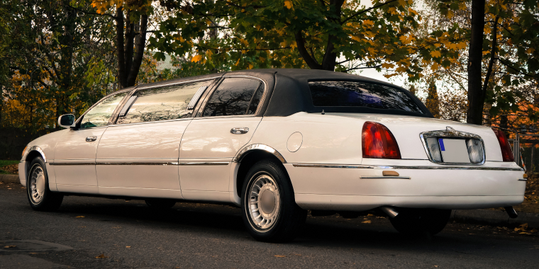 Lincoln TownCar Limousine or Limo on the roadside, among autumn trees.