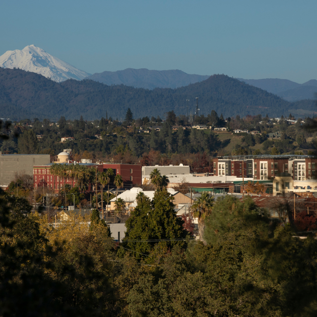 Afternoon snow covered view of the peak of Mount Shasta and the downtown skyline of Redding, California, USA.