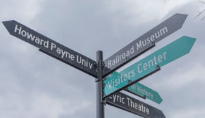 Street Sign with Directions to the Lyric Theatre, Museum of History, Railroad Museum, and Howard Payne University: Brownwood cheap car insurance in Texas.