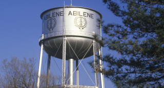 Abilene written on a water tower against clear sky, cheap car insurance in Texas.