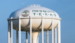 Large white water tower with tree logo print in northeast, Texas: Cheap car insurance in Mesquite, Texas.