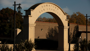 Late afternoon sun shines on the downtown welcome arches of San Leandro, California: Cheap car insurance in The Golden State.