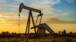 Active oil rig at working at sunrise or sunset: Cheap Car insurance in Odessa, Texas.