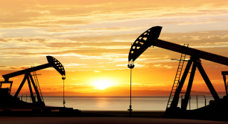 Silhouette of working oil pumps on sunset background: Cheap car insurance in Pampa, Texas.