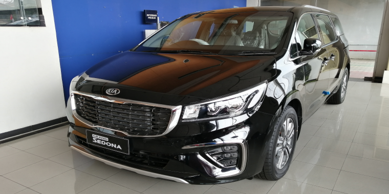 Kia Sedona car on display at a showroom.