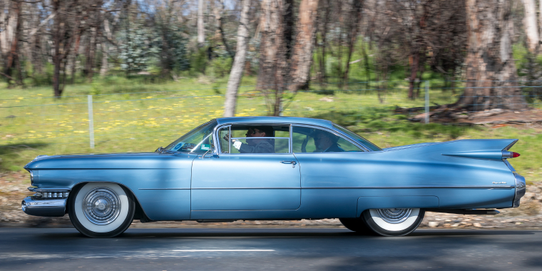 Vintage 1959 Cadillac De Ville Coupe driving on country roads near the town of Birdwood, South Australia.