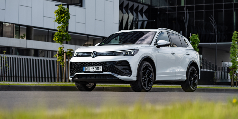 Volkswagen Tiguan R-Line Third generation, Compact crossover SUV, stands on road at sunset by modern office. Front and side view. 7 June 2024 Riga, Latvia.