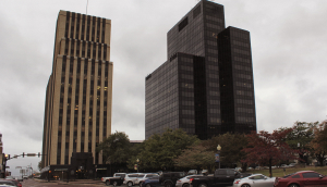 Road and cars parked in Historic Downtown Tyler, TX on cloudy afternoon.