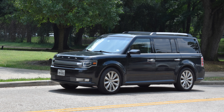 Ford Flex SUV cruising at a nature reserve in Houston, Texas, USA. 