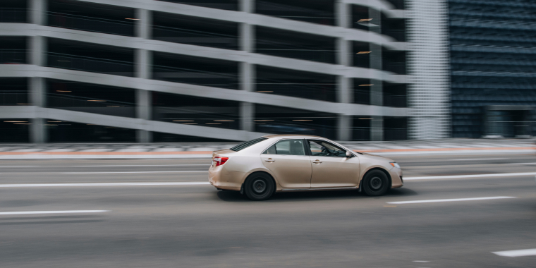 White Toyota Matrix car moving on the street, Ukraine, Kyiv.