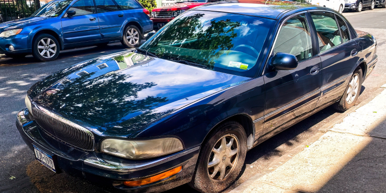 A blue Buick Park Avenue full-size sedan parked on the street.