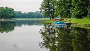 Summer Day At The Lake. Paddleboats and canoes line the shore of the lake at Scioto State Park in Chillicothe, Ohio