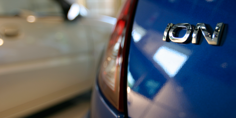  A blue Saturn Ion sits in a show room of a dealership in Paramus, New Jersey – cheap car insurance