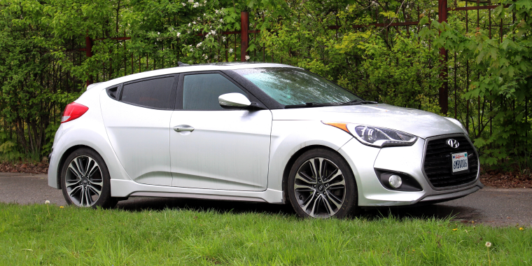 Grey Hyundai Veloster on the city street in rainy weather in Vinnytsia, Ukraine - Hyundai, cheap car insurance. 