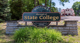The Welcome to State College sign on N Atherton St on a sunny summer day on June 4, 2023 in State College – cheap car insurance in Pennsylvania.