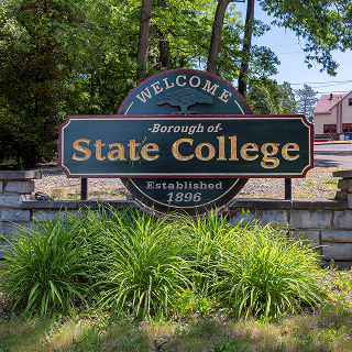 The Welcome to State College sign on N Atherton St on a sunny summer day on June 4, 2023 in State College – cheap car insurance in Pennsylvania.