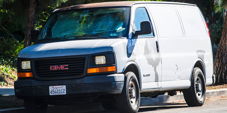 Los Angeles USA A white GMC Savana cargo van parked on a street – cheap car insurance.