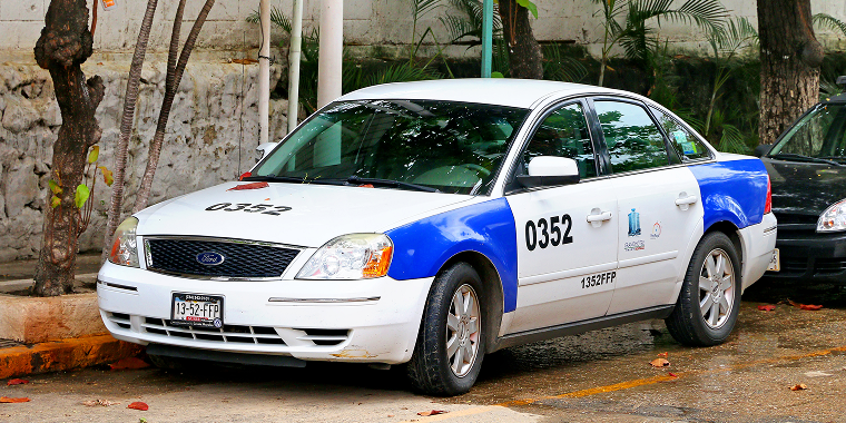 Taxi car Ford Five Hundred in the city street – Ford, cheap car insurance.