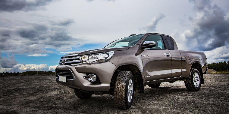 Brown Toyota Pickup running on the big sand field on August 2017 in Pirkkala, Finland – Best cheap car insurance for a Toyota. 
