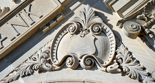 Embellished shield with swirling banner are part of the architecture on the Ruston State Bank in Ruston – cheap car insurance in Louisiana.