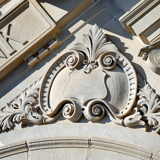 Embellished shield with swirling banner are part of the architecture on the Ruston State Bank in Ruston – cheap car insurance in Louisiana.