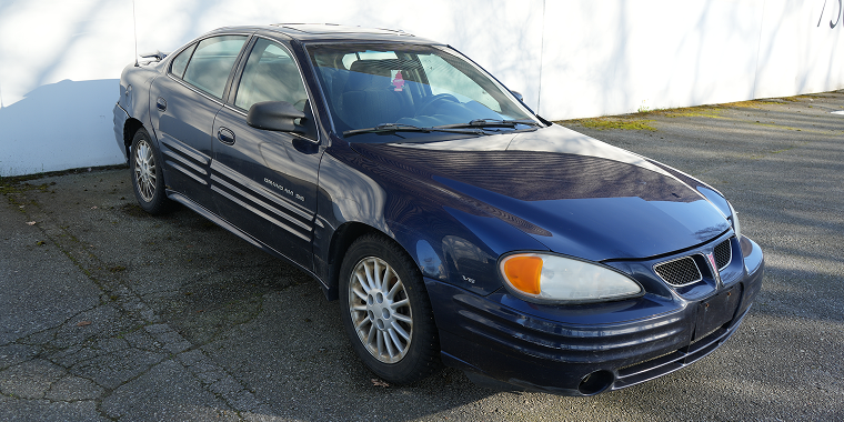 Blue Pontiac Grand Am sedan parked in Richmond, B.C., Canada on 03-29-2025—cheap car insurance for Pontiac.