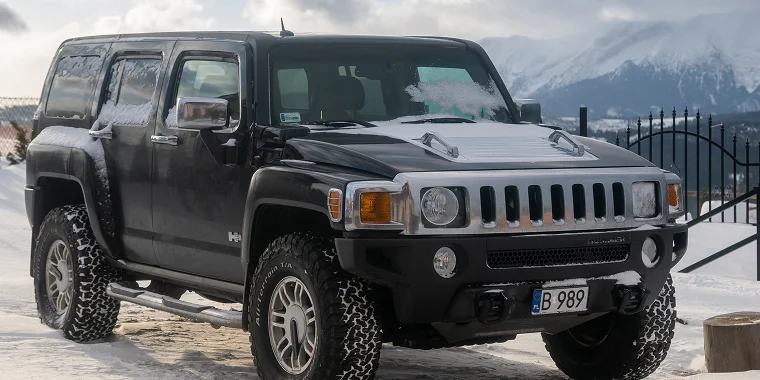 Black Hummer H3 in the snow, cheap car insurance.