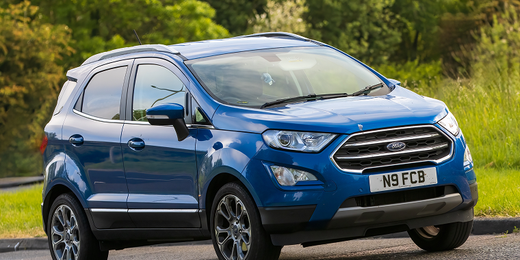 Blue Ford EcoSport car travelling on an English country road, cheap car insurance.