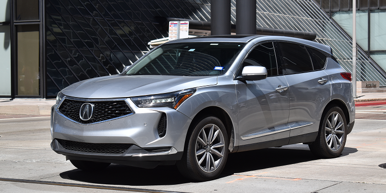 An Acura RDX SUV cruising downtown's financial district in Houston, TX USA on 9-28-2024 — Cheap car insurance.