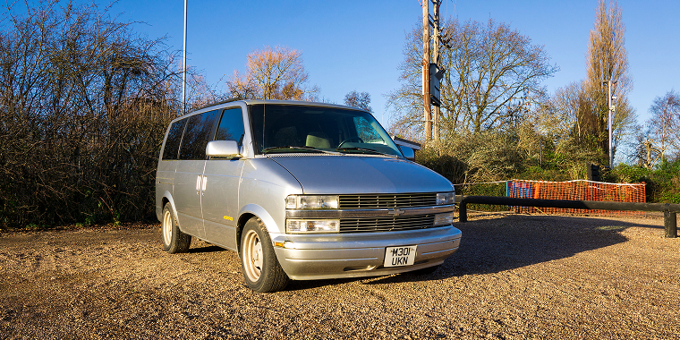 Gray Chevrolet Uplander parked in a deserted yard in front of a wooden fence – Chevrolet, cheap car insurance. 