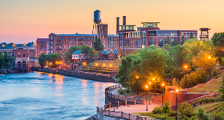 Columbus, Georgia, USA downtown skyline on the Chattahoochee River at dusk.
