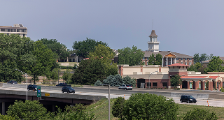 Overland Park, Kansas, USA - June 17, 2023: Morning traffic passes through the downtown commercial district of Overland Park.
