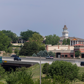Overland Park, Kansas, USA - June 17, 2023: Morning traffic passes through the downtown commercial district of Overland Park.