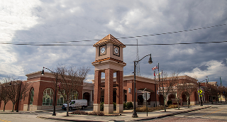 Douglasville, Georgia USA - 2 10 2023: The Douglasville Conference Center surrounded by bare winter trees, lush green plants and tall light posts with powerful clouds on Church Street in Douglasville.