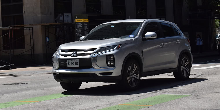 A gray Mitsubishi Endeavor sport in the downtown financial district of Houston. Cheap car insurance.