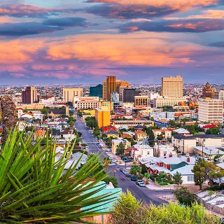 El Paso, Texas, USA downtown city skyline at dusk with Juarez, Mexico in the distance – cheap car insurance in Texas.