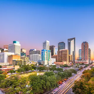 Houston, Texas, USA downtown park and skyline at twilight – cheap car insurance in Texas.