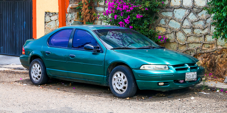 Motor car Dodge Stratus in a city street — Cheap car insurance.