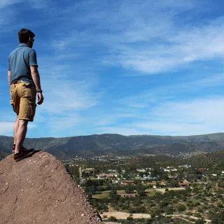 Santa Clarita, California - May 31 2015: A man stands at the peak of the famous Vasquez Rocks. Cheap car insurance in California.